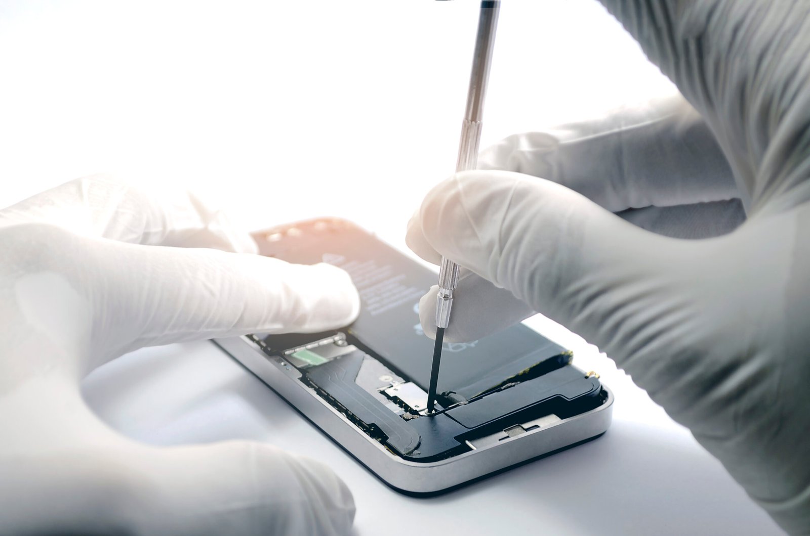 Close-up of smartphone repair technicians repairing a mobile phone